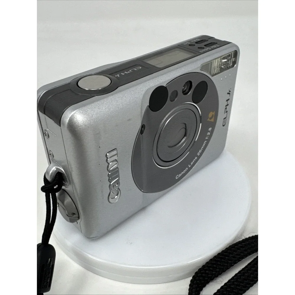 CANON Elph Jr. APS Film Camera, 26mm‎ f2.8 Wide Angle Lens, Silver w/ Case WORKS
